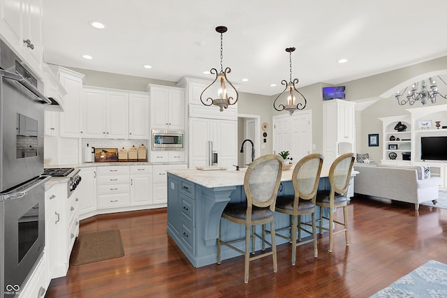 3441 S Overlook Pass, New Palestine, IN 46163 - kitchen with stainless steel appliances, white cabinetry, tasteful backsplash, a center island with sink, and recessed lighting