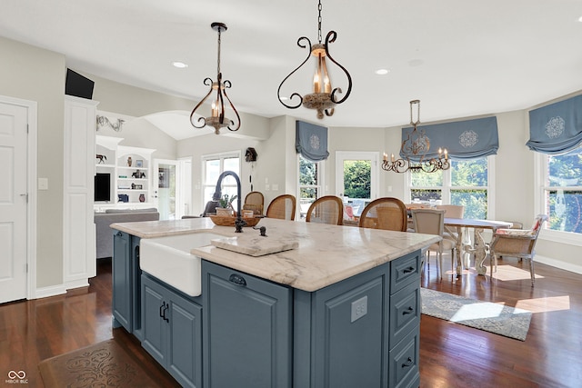 3441 S Overlook Pass, New Palestine, IN 46163 - kitchen featuring a chandelier, healthy amount of natural light, dark wood-style flooring, an island with sink, and lofted ceiling