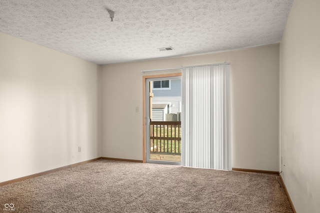 spare room with carpet and a textured ceiling