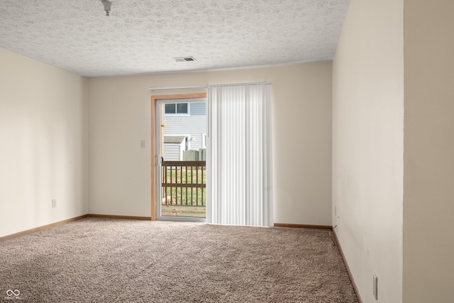 unfurnished room featuring carpet floors and a textured ceiling