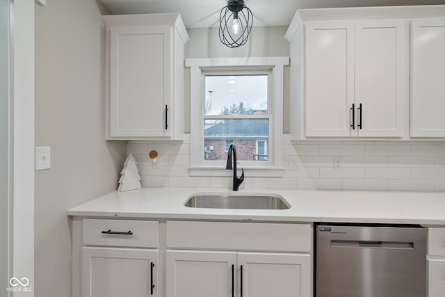 kitchen with dishwasher, white cabinetry, and sink