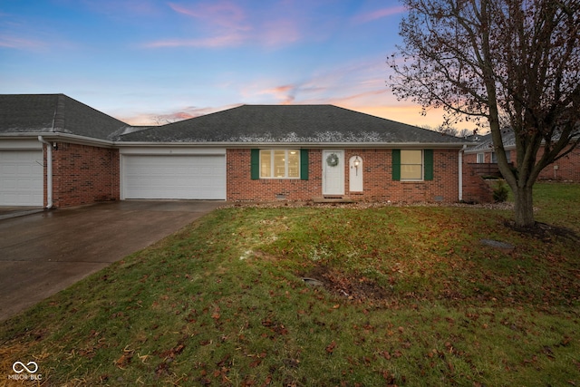 ranch-style home with a yard and a garage