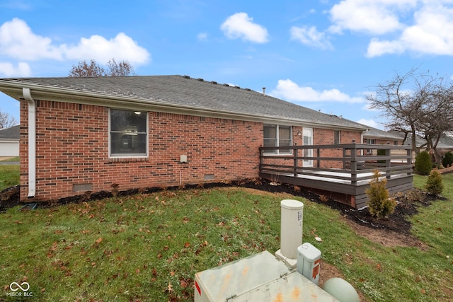 back of house with a wooden deck and a yard