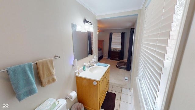 bathroom with ceiling fan, tile patterned floors, toilet, vanity, and ornamental molding