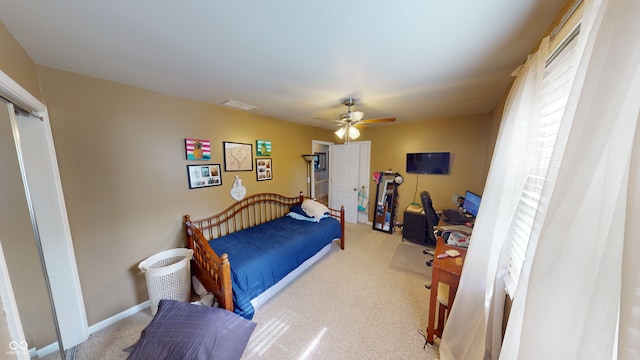 bedroom featuring ceiling fan and light carpet