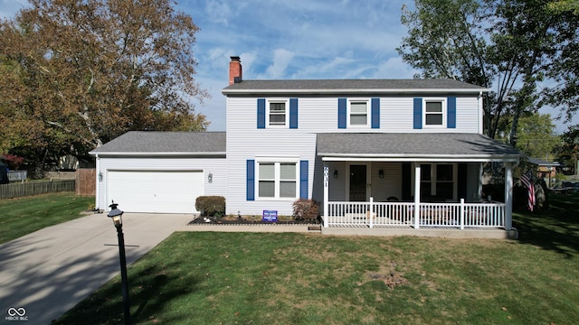 view of front of home featuring covered porch, a garage, and a front yard