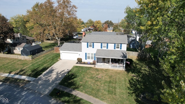 exterior space with a yard, covered porch, and a garage