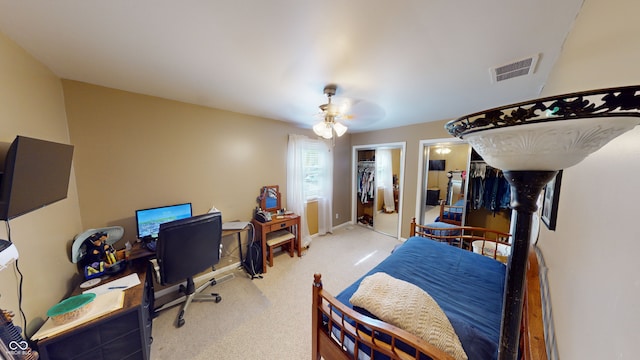 carpeted bedroom featuring a spacious closet, a closet, and ceiling fan