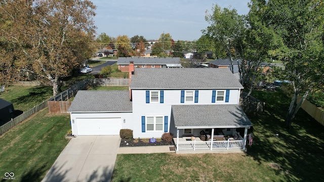 exterior space featuring a porch, a yard, and a garage