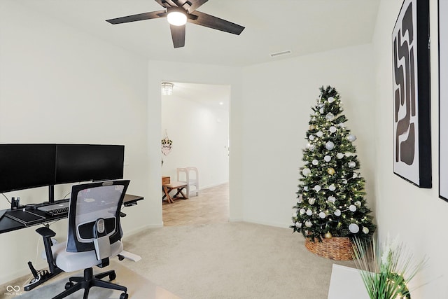 office with light carpet and ceiling fan