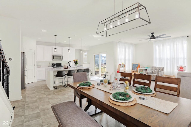 dining area featuring ceiling fan and sink