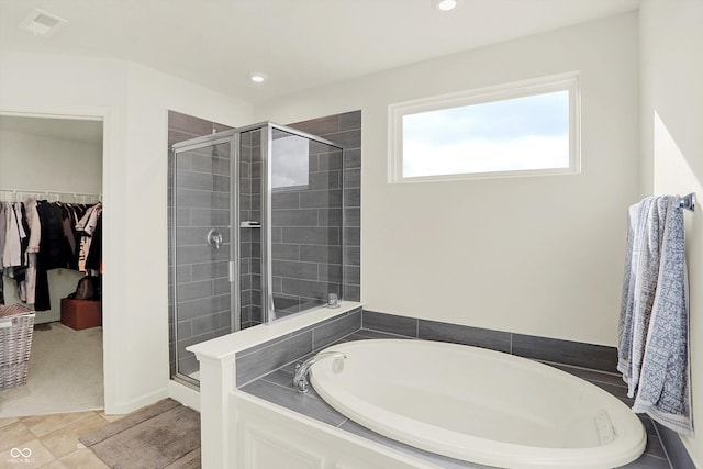 bathroom featuring tile patterned floors and separate shower and tub