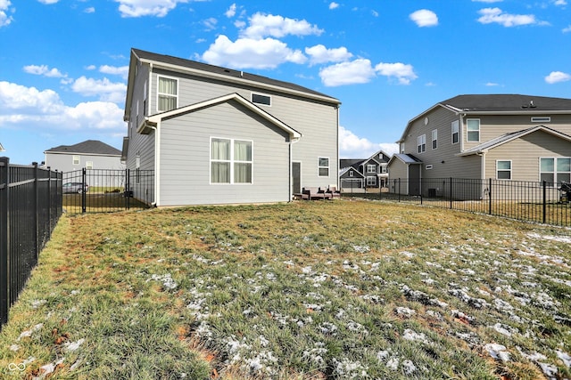 rear view of property featuring a lawn