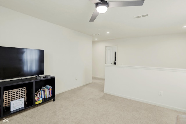 carpeted living room with ceiling fan