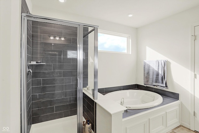 bathroom with separate shower and tub