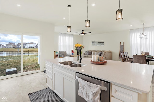 kitchen with stainless steel dishwasher, ceiling fan, sink, decorative light fixtures, and white cabinetry