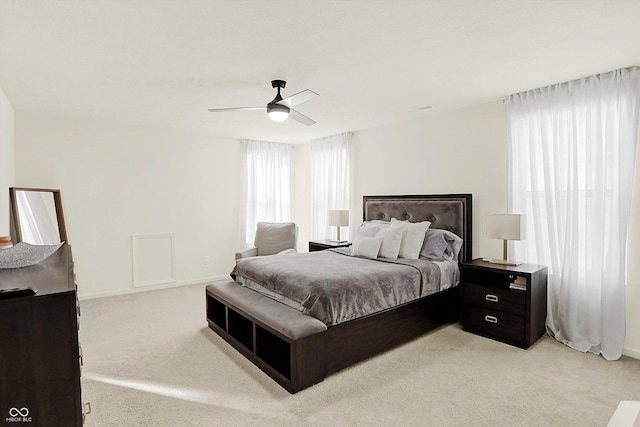 bedroom with ceiling fan and light carpet