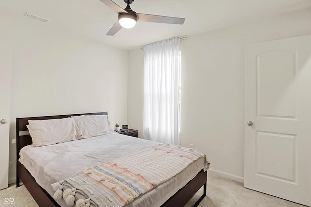 bedroom with light carpet and ceiling fan