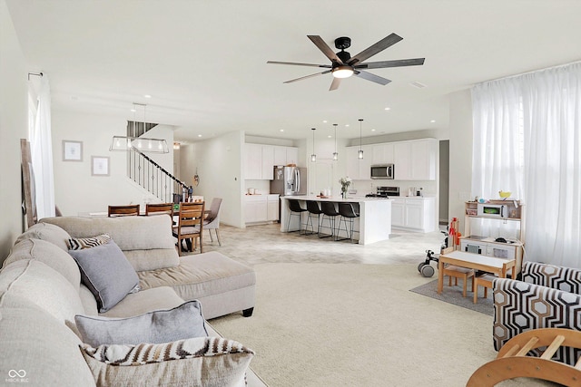 living room featuring ceiling fan and light carpet