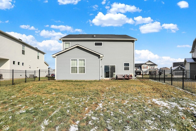 rear view of property featuring a lawn