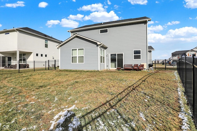 rear view of property featuring a yard