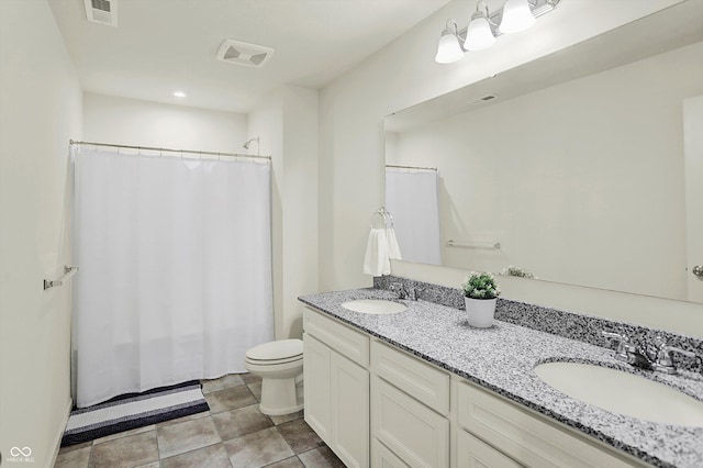 bathroom featuring vanity, toilet, and curtained shower