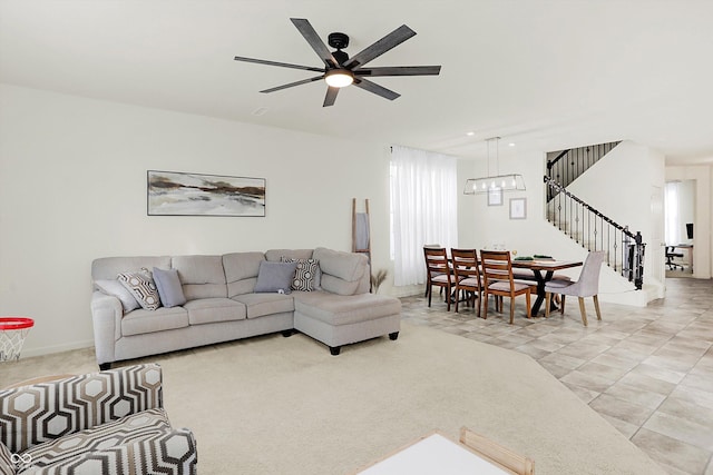 living room with ceiling fan and light colored carpet