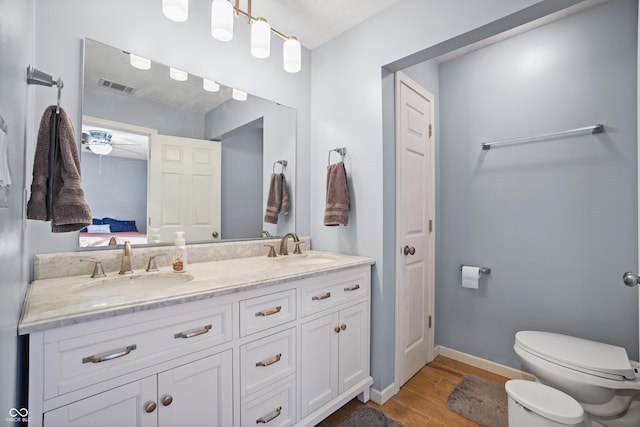 bathroom featuring vanity, ceiling fan, toilet, and wood-type flooring