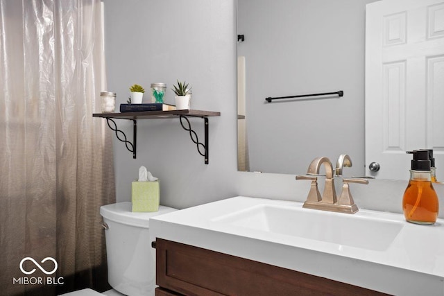 bathroom with vanity and toilet