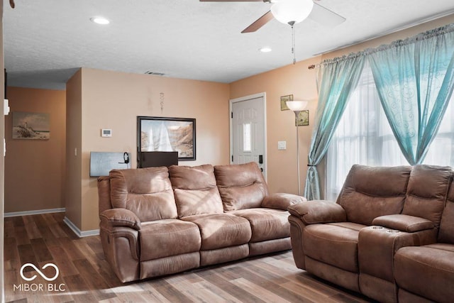 living room with wood-type flooring and ceiling fan