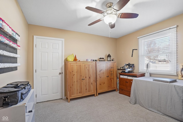 interior space featuring ceiling fan and light colored carpet