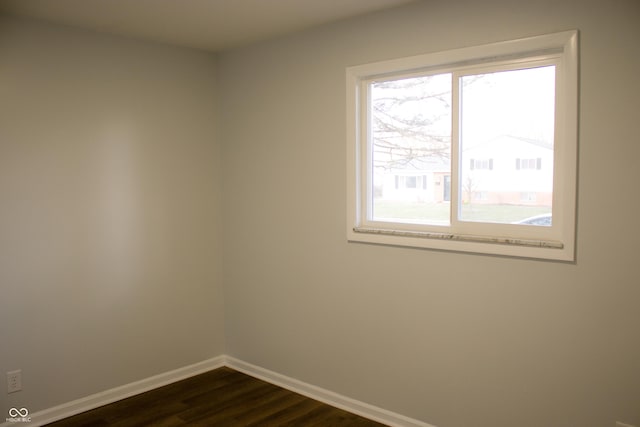 unfurnished room with dark wood-type flooring