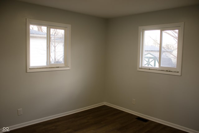 spare room featuring dark hardwood / wood-style flooring