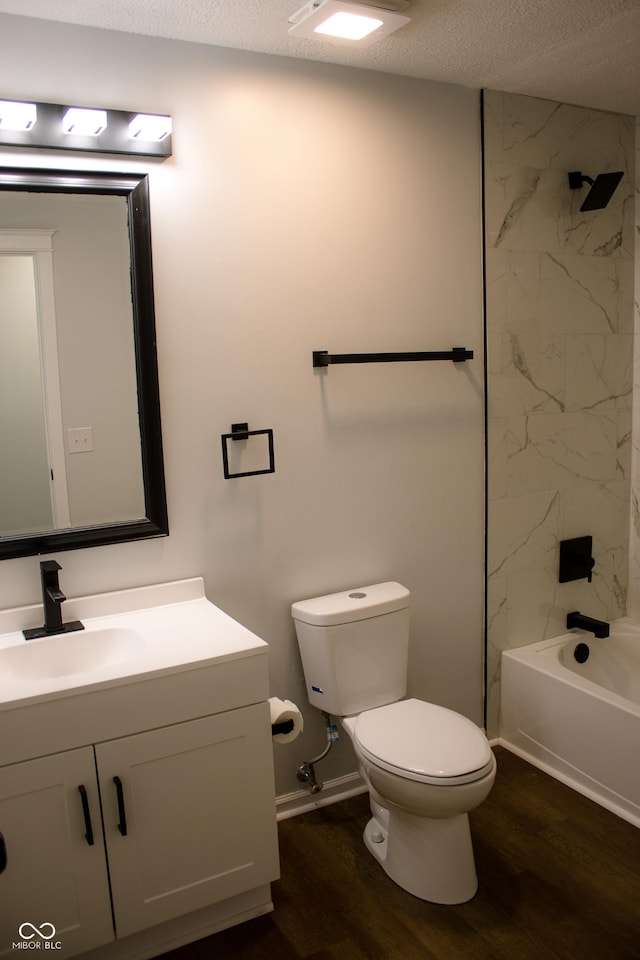 full bathroom featuring vanity, a textured ceiling, hardwood / wood-style flooring, and tiled shower / bath