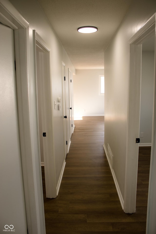 corridor with dark wood-type flooring