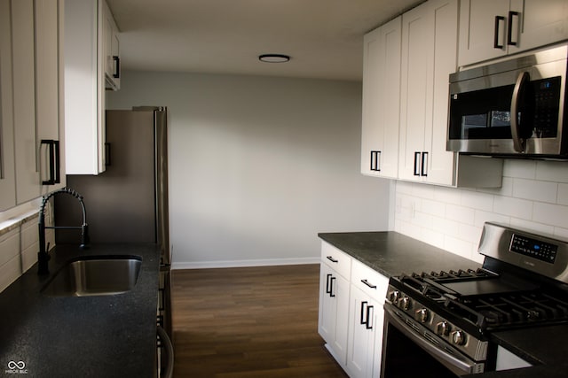 kitchen featuring sink, stainless steel appliances, tasteful backsplash, dark hardwood / wood-style flooring, and white cabinets