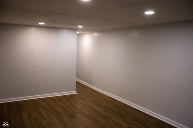 spare room with dark hardwood / wood-style flooring