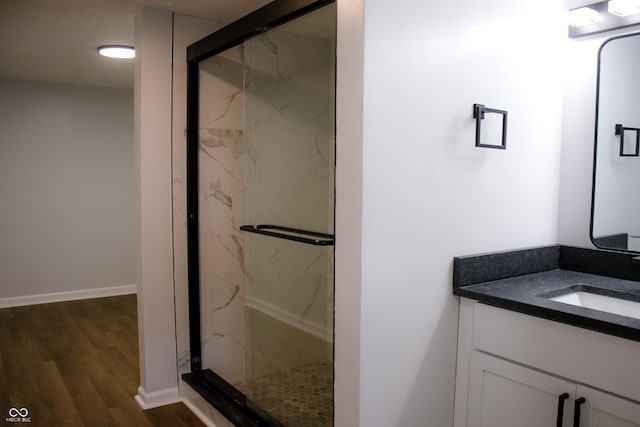 bathroom with vanity, hardwood / wood-style flooring, and walk in shower