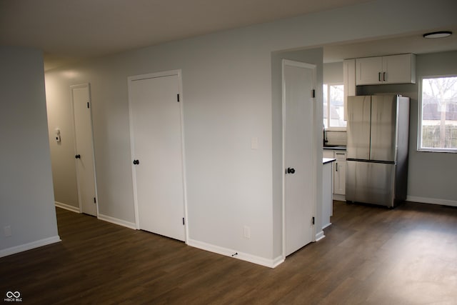 unfurnished room featuring sink and dark hardwood / wood-style floors