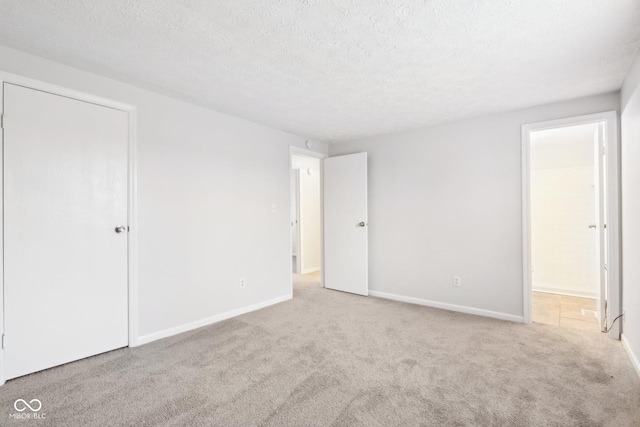 carpeted empty room with a textured ceiling