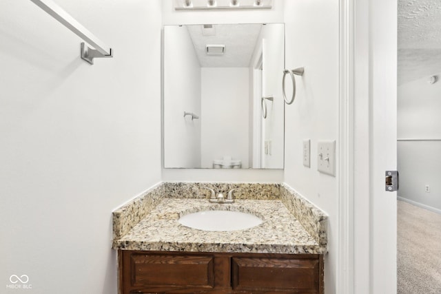 bathroom featuring vanity and a textured ceiling