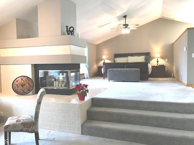 bedroom with ceiling fan, lofted ceiling, and carpet floors