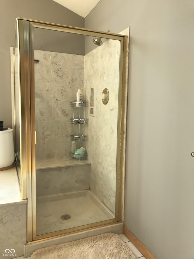 bathroom featuring a shower with door