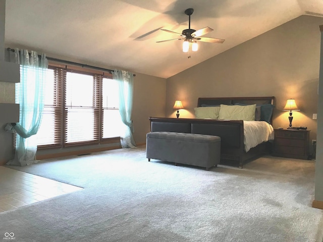 carpeted bedroom with ceiling fan and lofted ceiling