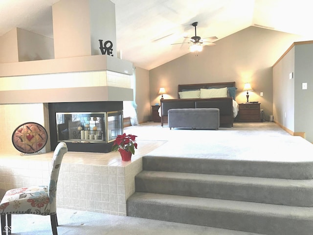 bedroom with ceiling fan, carpet floors, and vaulted ceiling