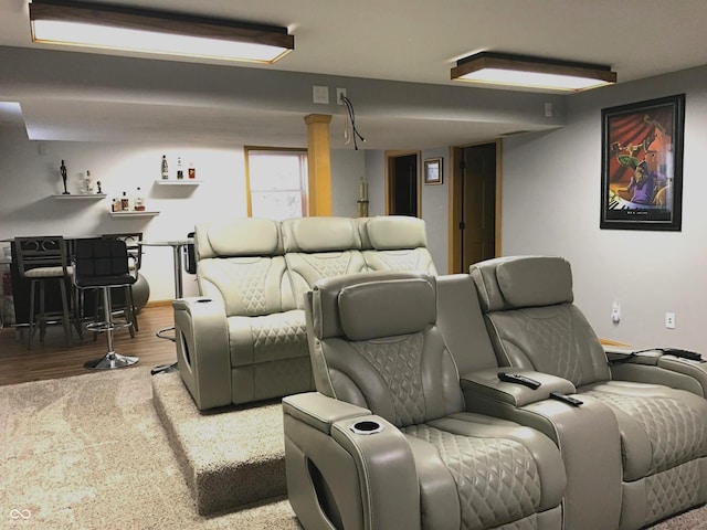 home theater featuring wood-type flooring and indoor bar