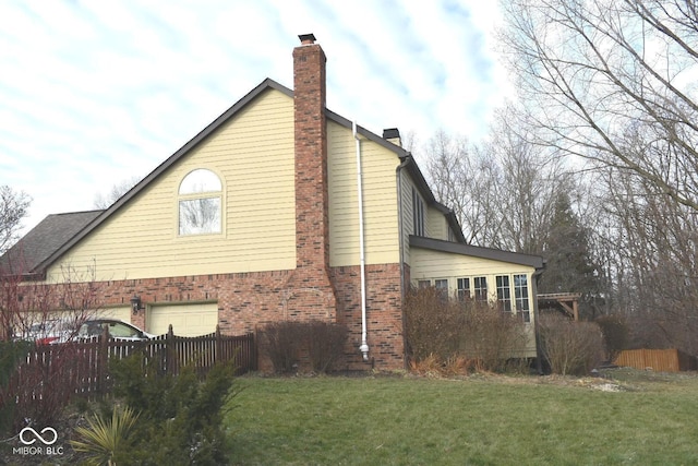 view of side of home with a garage and a yard