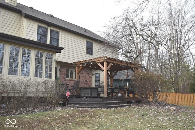 rear view of house with a pergola and a deck