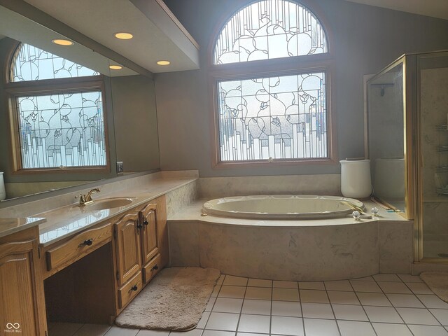 bathroom featuring tile patterned floors, a wealth of natural light, vanity, and independent shower and bath