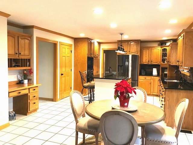 kitchen with stainless steel refrigerator with ice dispenser, ornamental molding, sink, light tile patterned floors, and hanging light fixtures